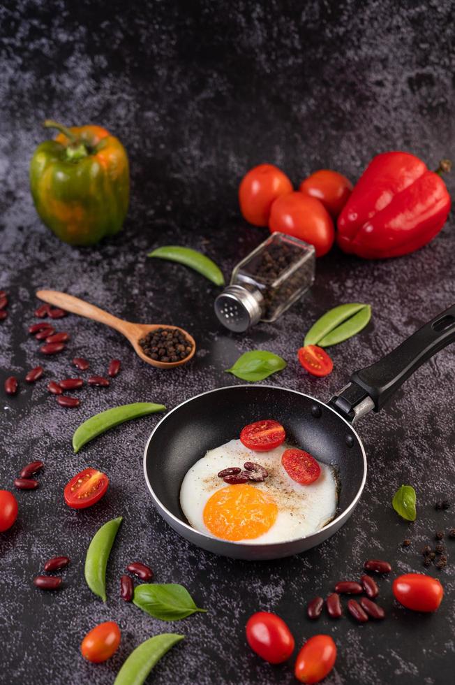 Fried eggs in a frying pan with beans photo