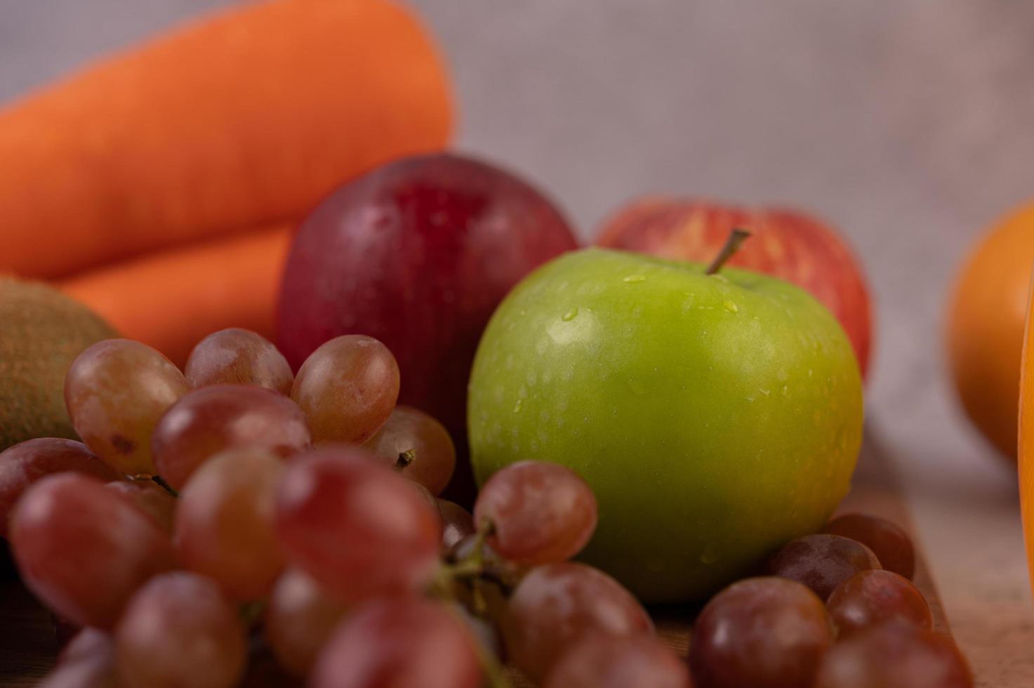 Apples, grapes, carrots and oranges photo