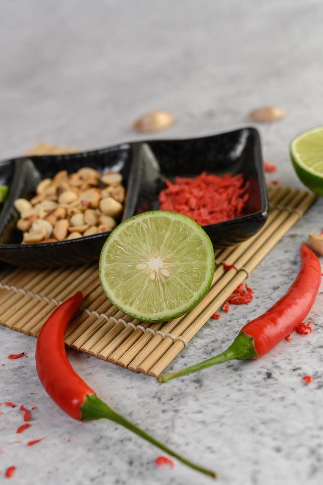 Red pepper with limes and peanuts photo