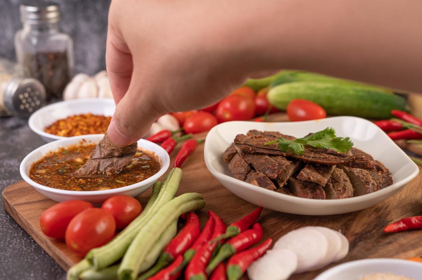 Dipping grilled pork liver photo