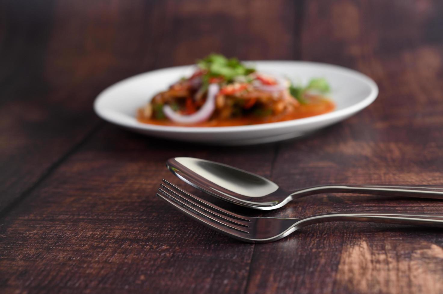 Selective focus of stainless spoon and fork photo