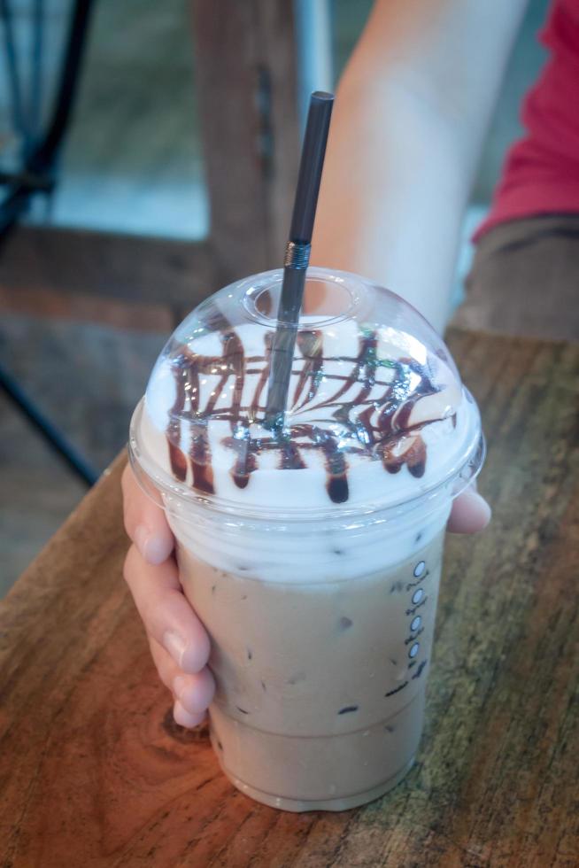 Person holding a frozen coffee photo