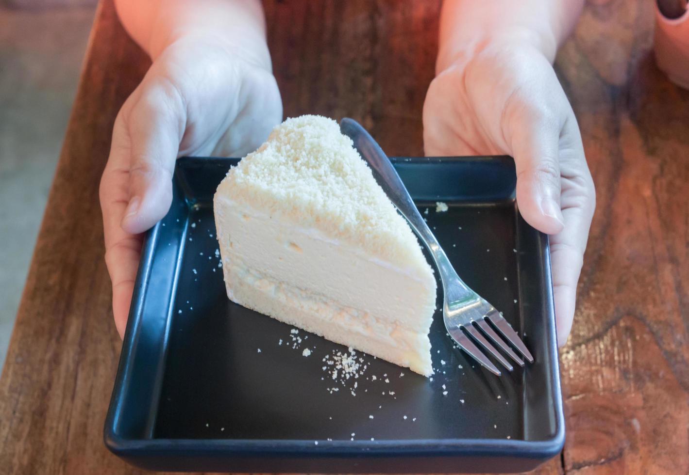 Person holding a piece of cake photo