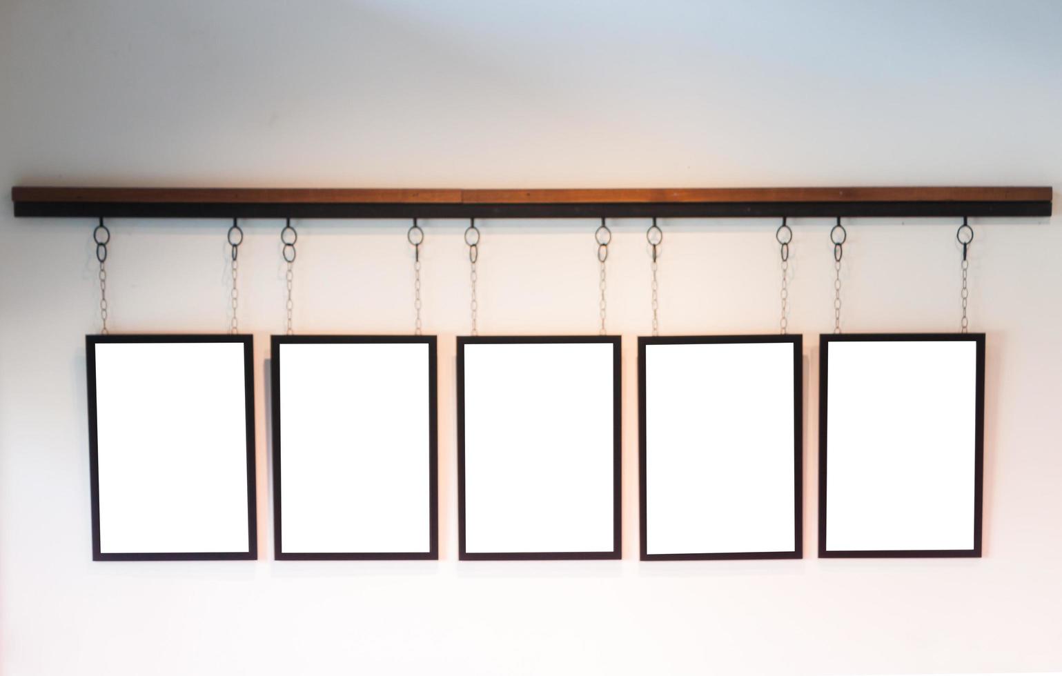 Blank boards hanging on white wall background photo