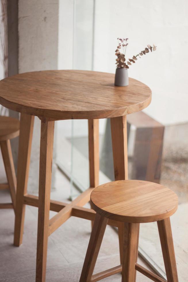 Wooden table and chairs with flowers photo