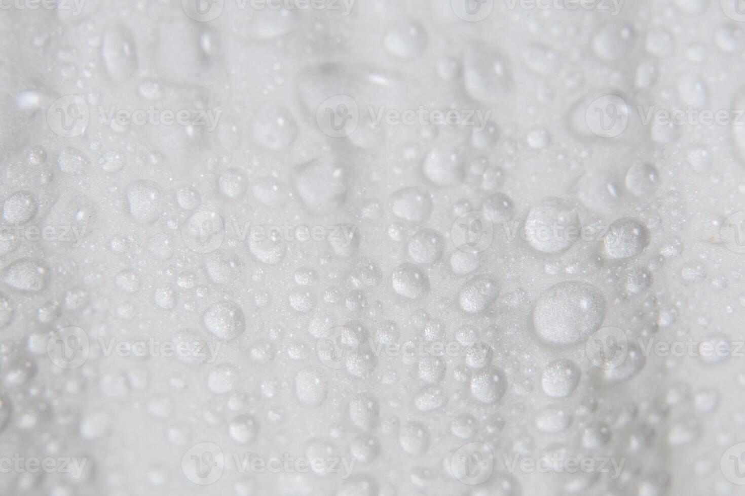A close up of a white towel with water droplets photo