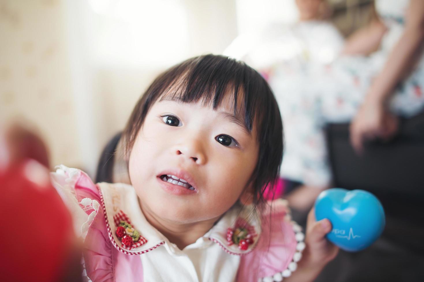 Portrait of a little asian girl playing in her home photo