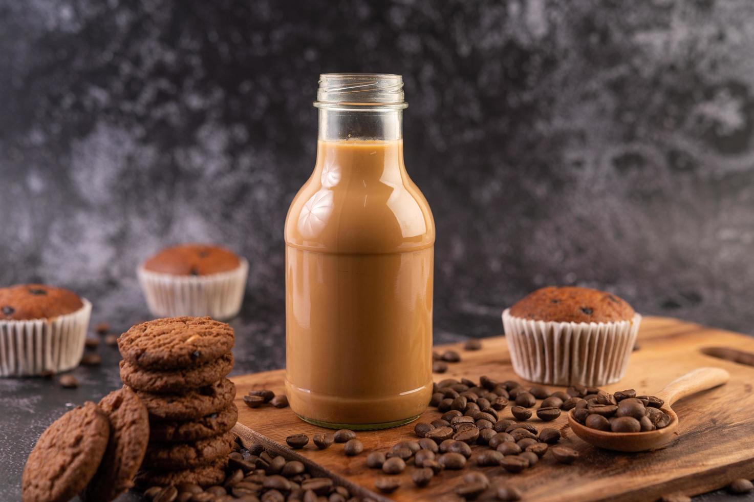 Cookies with coffee beans and milk photo