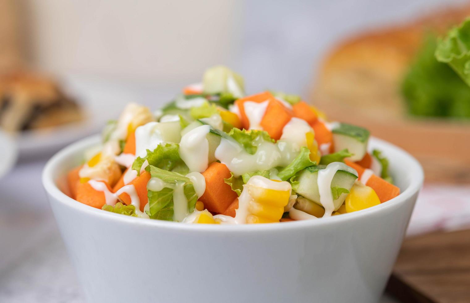 Cucumber, corn, carrot and lettuce salad photo