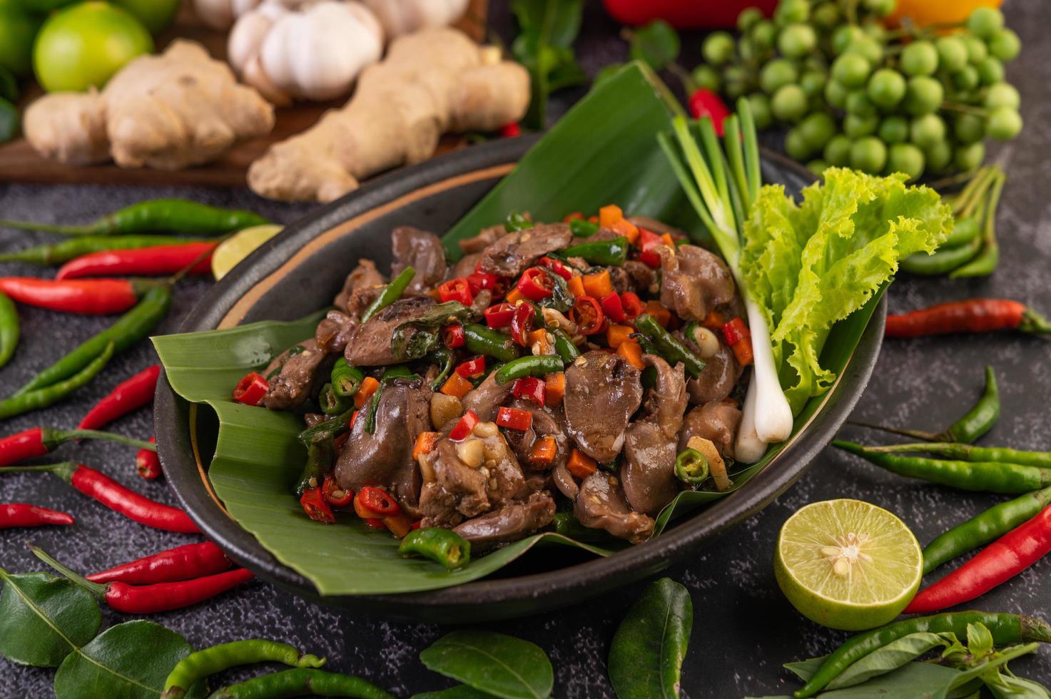 Stir-fried basil chicken liver on banana leaves photo