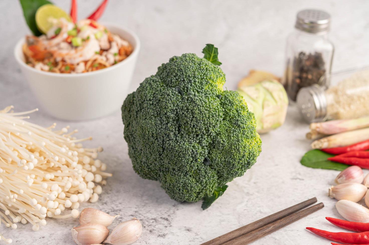 Broccoli, golden needle mushroom, chopsticks, garlic and chilies photo