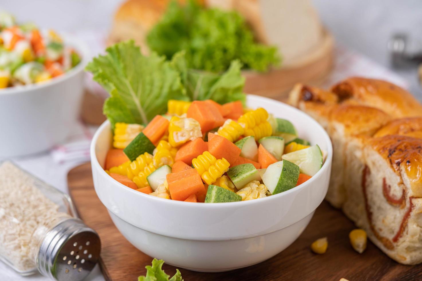 Cucumber, corn, carrot and lettuce salad photo