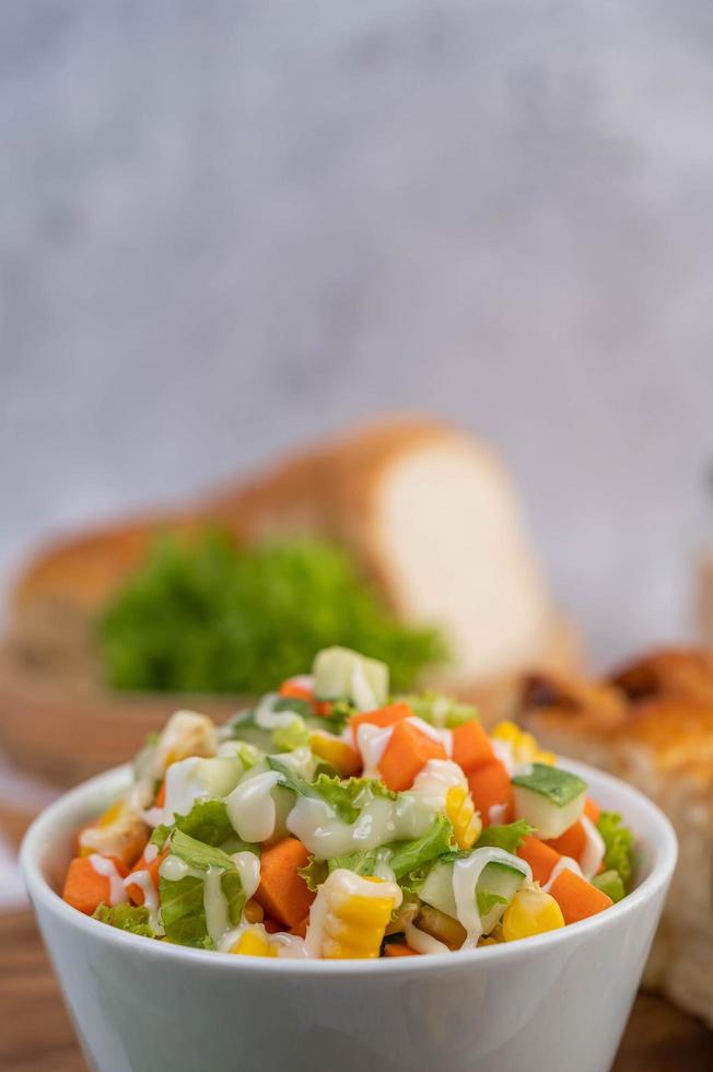 Cucumber, corn, carrot and lettuce salad photo