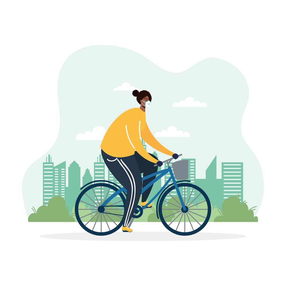 young African man riding bicycle wearing medical mask vector