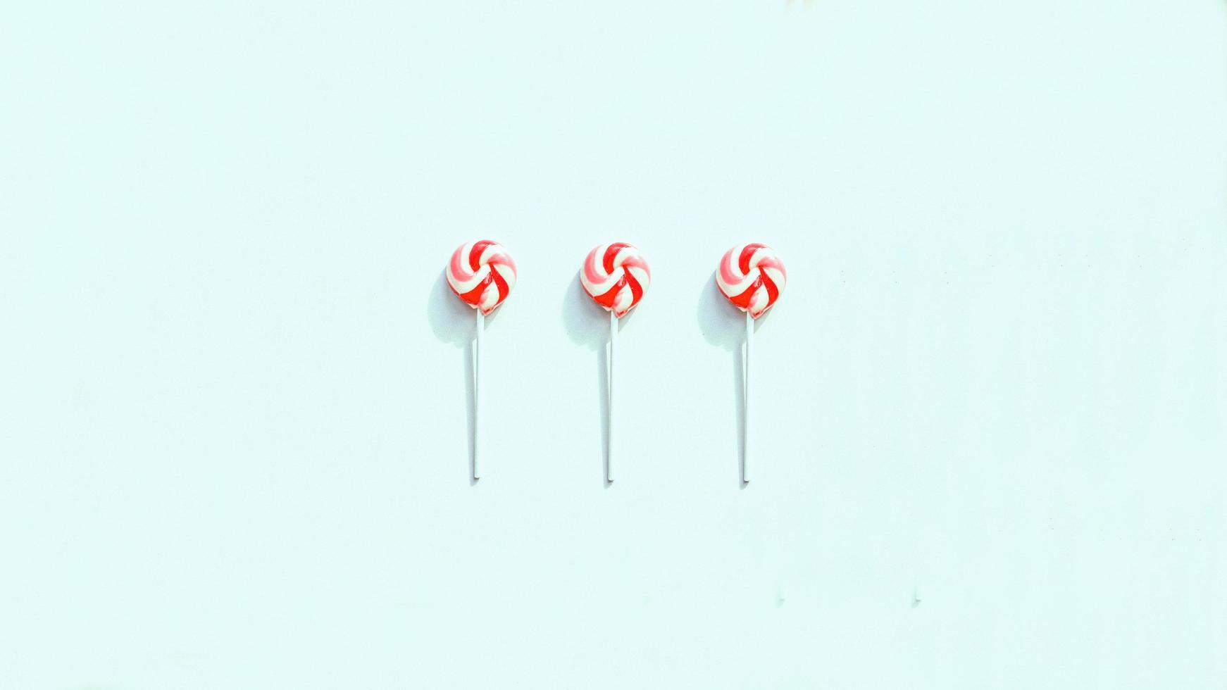 Peppermint lollipops on a blue surface photo