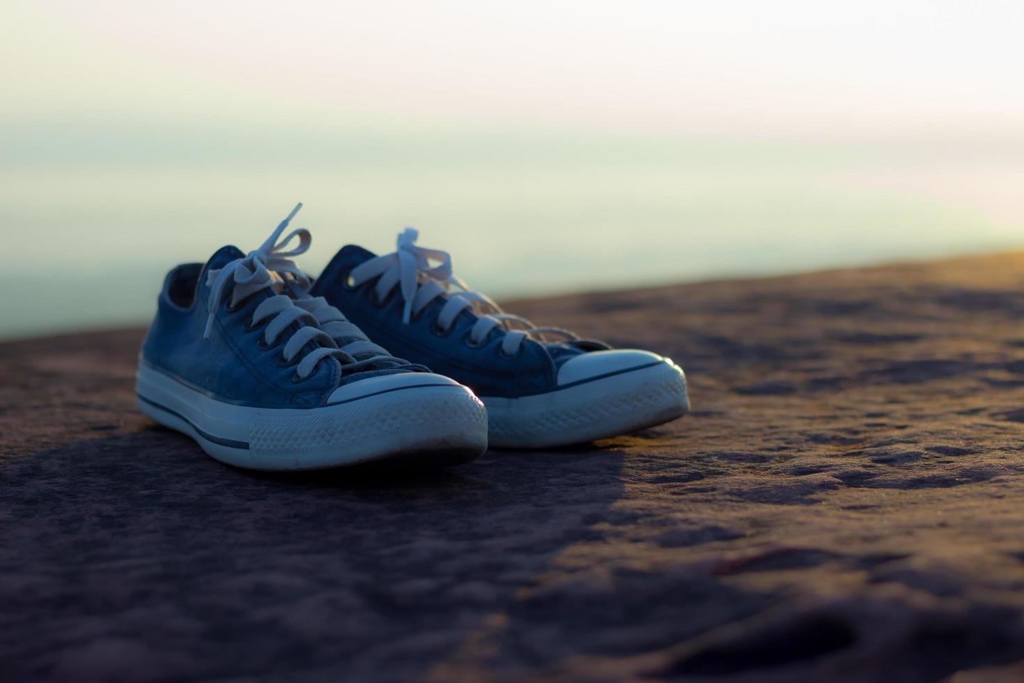 Pair of shoes on a rock photo