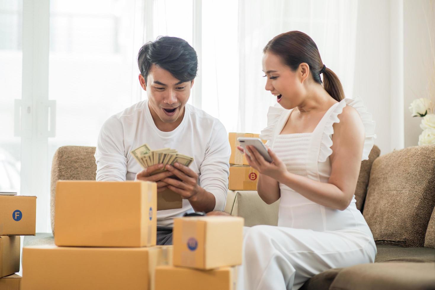 Happy couple at home office with online business photo