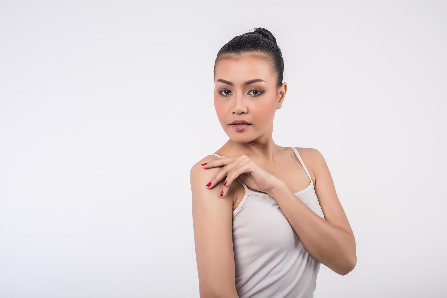 Woman on white background poses for camera photo