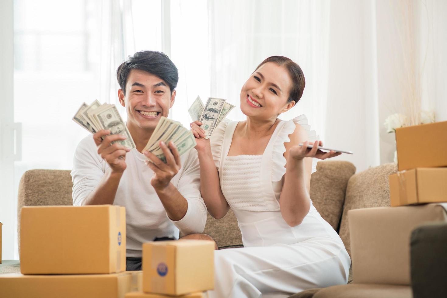 Happy couple at home office with online business photo