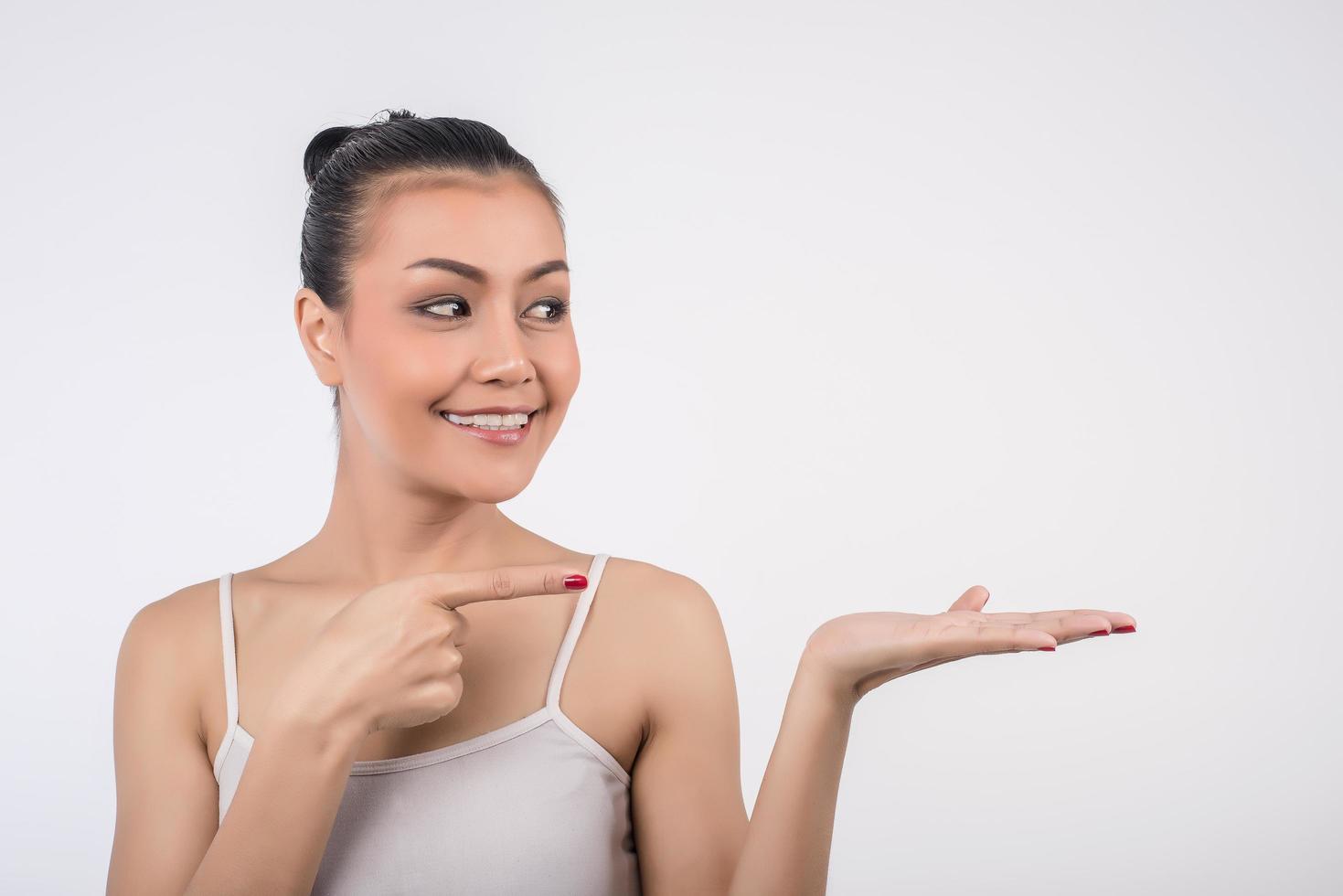 Beauty spa woman smiles with empty hand photo