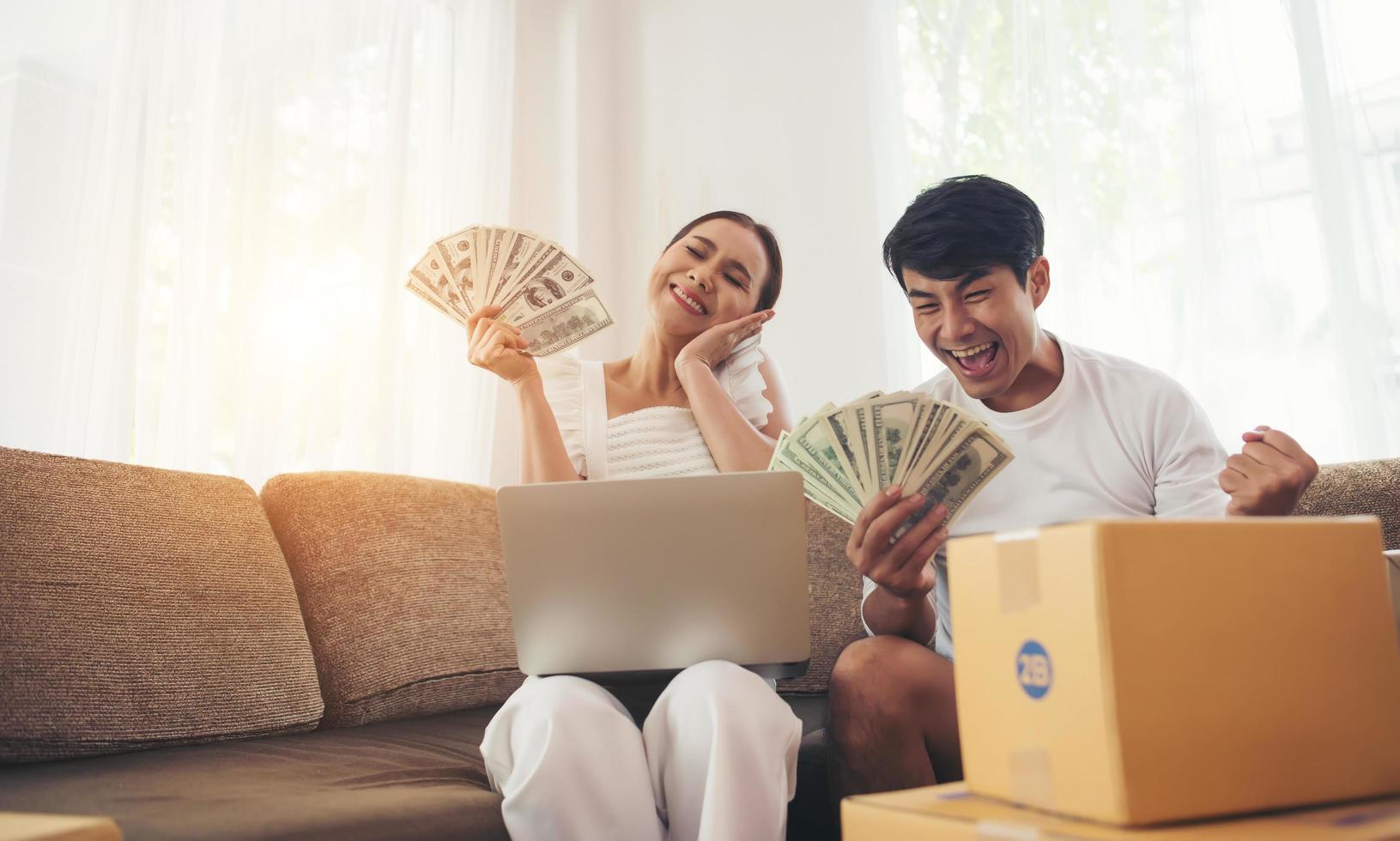 Happy couple at home office with online business photo