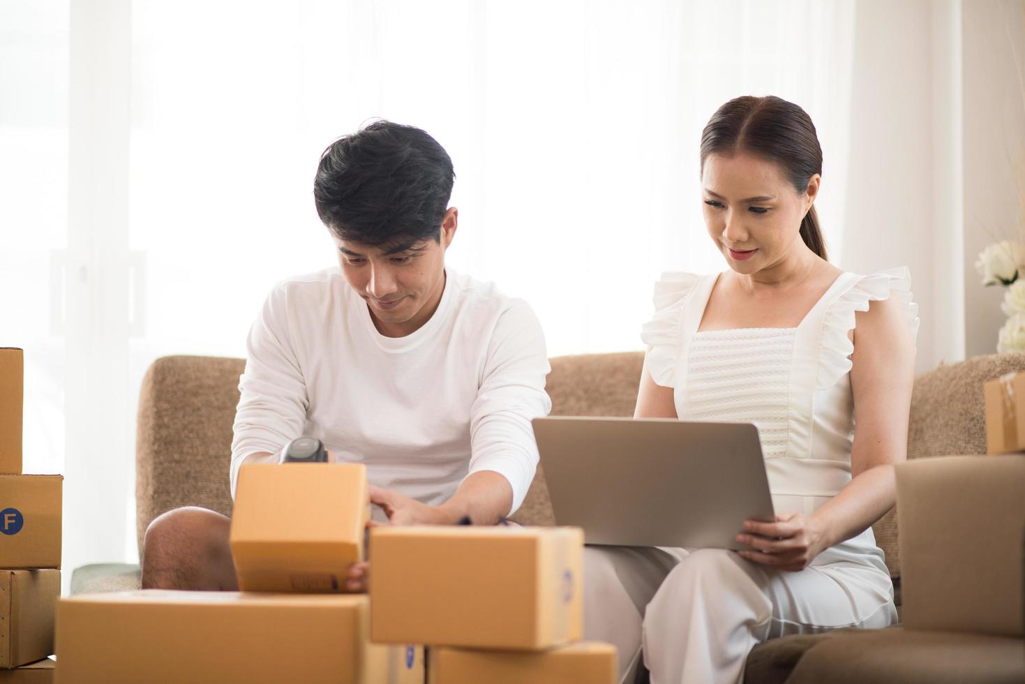 Happy couple at home office with online business photo