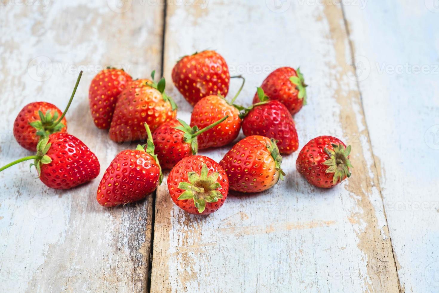 Strawberries on a wooden table photo