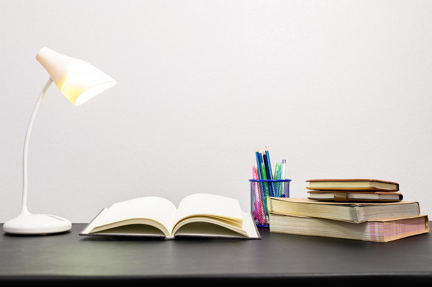 Books and stationeries on the desk photo