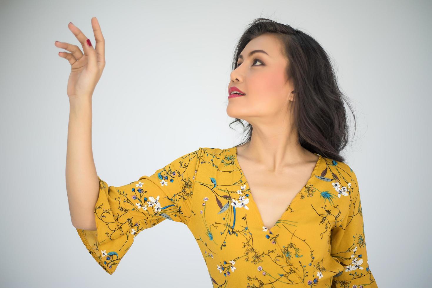 Close-up image of a woman in a yellow dress photo