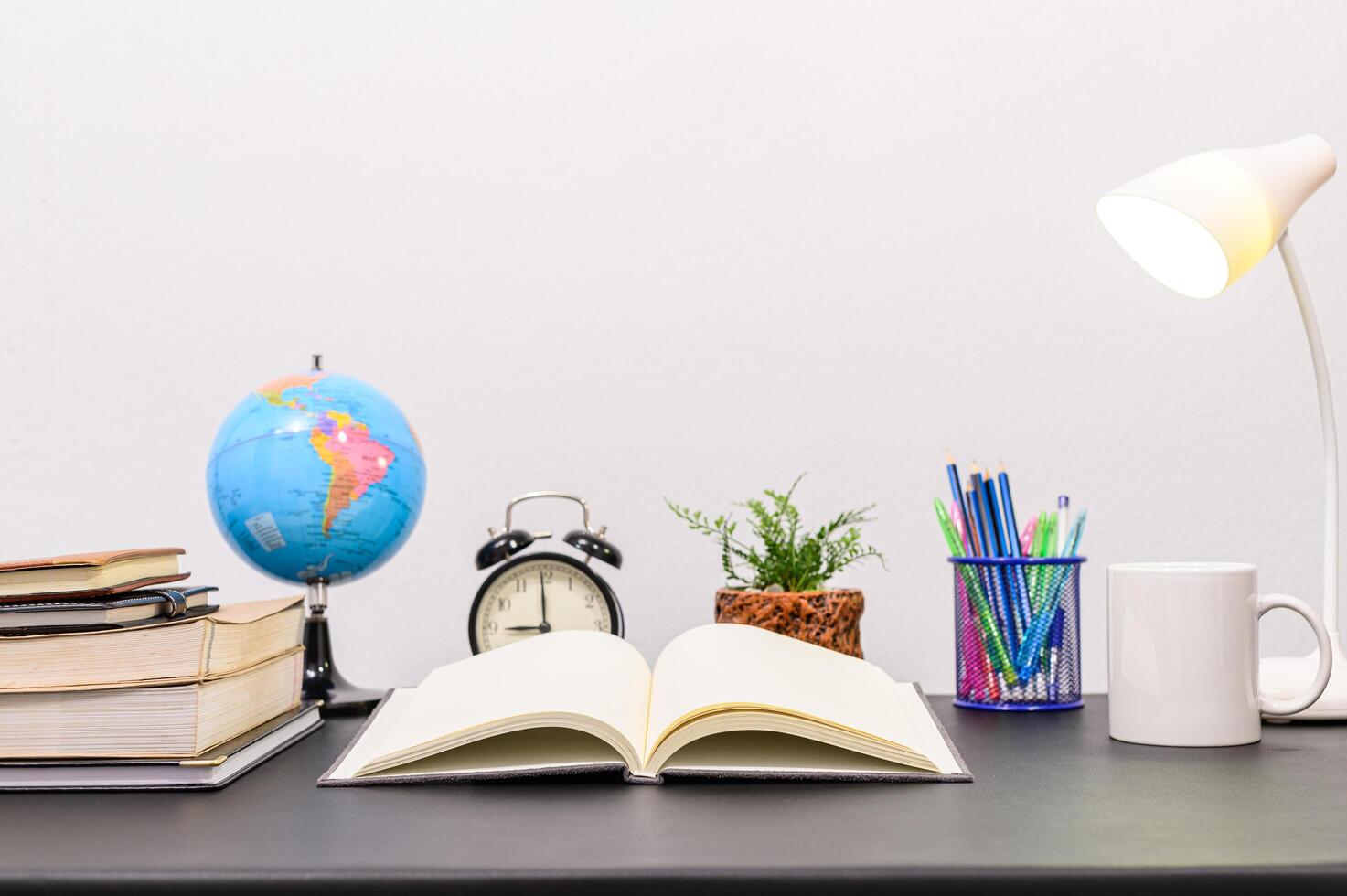 Books and stationeries on the desk photo