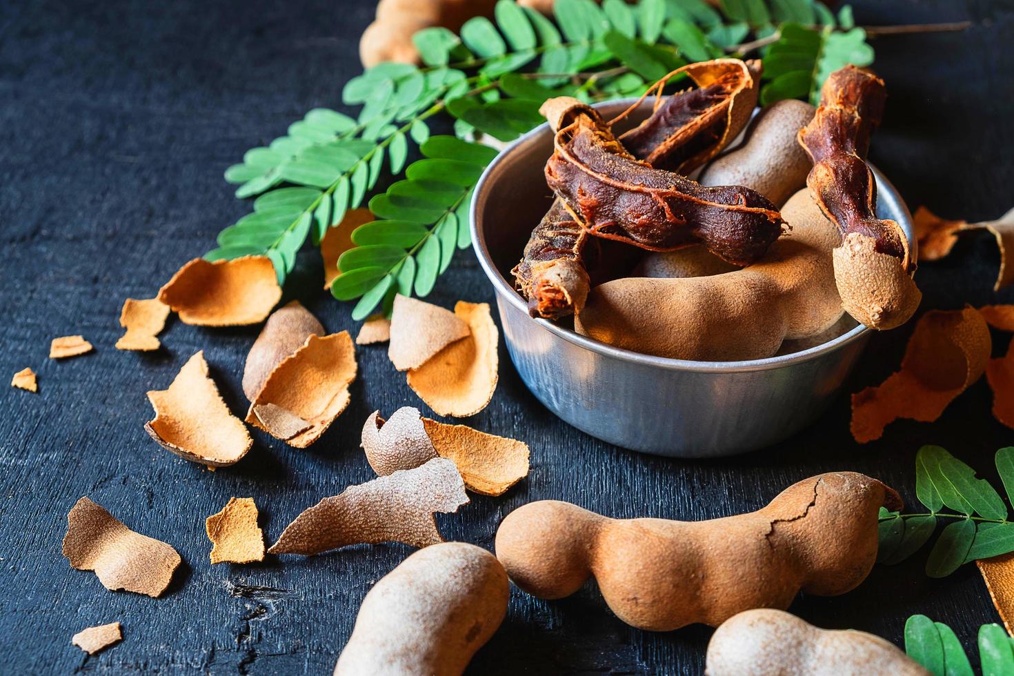 Bowl of tamarind on a black background photo