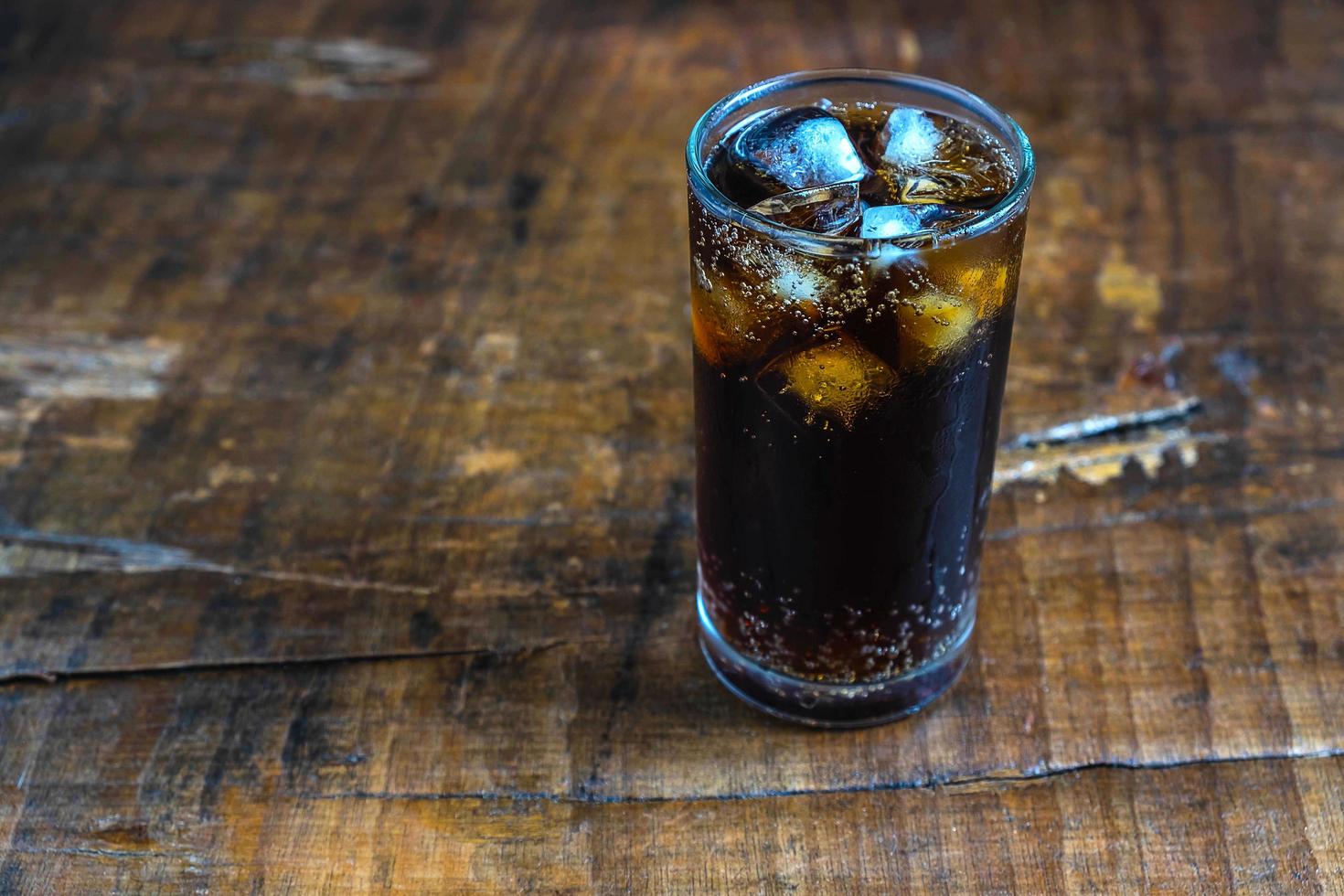 Iced cola on a rustic table photo