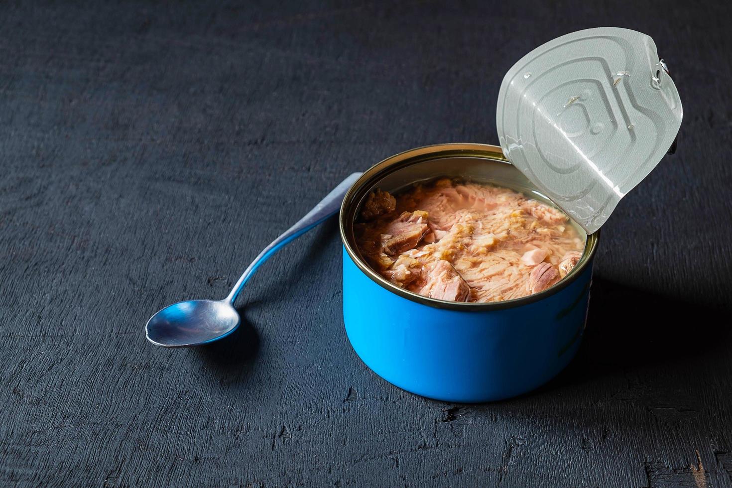 Canned tuna on a black background photo