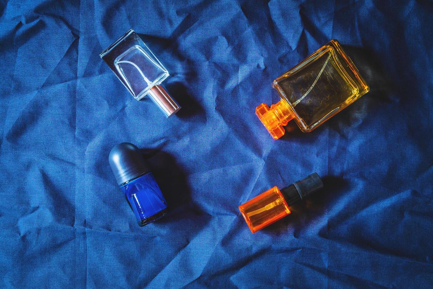 Perfume bottles on blue cloth photo