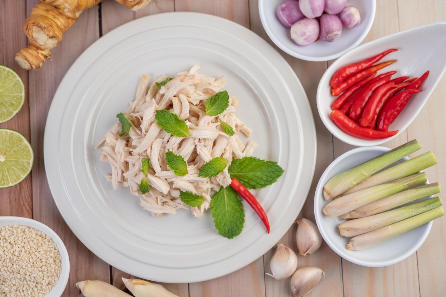 Chicken salad on a white plate with mint leaves photo