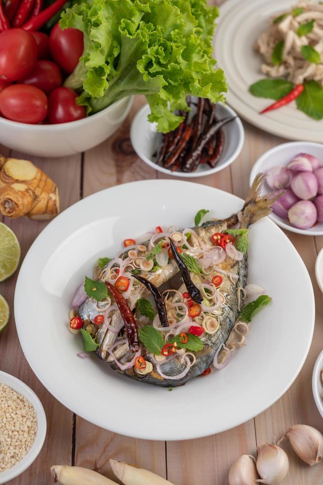 Deep-fried mackerel topped with pepper and mint photo