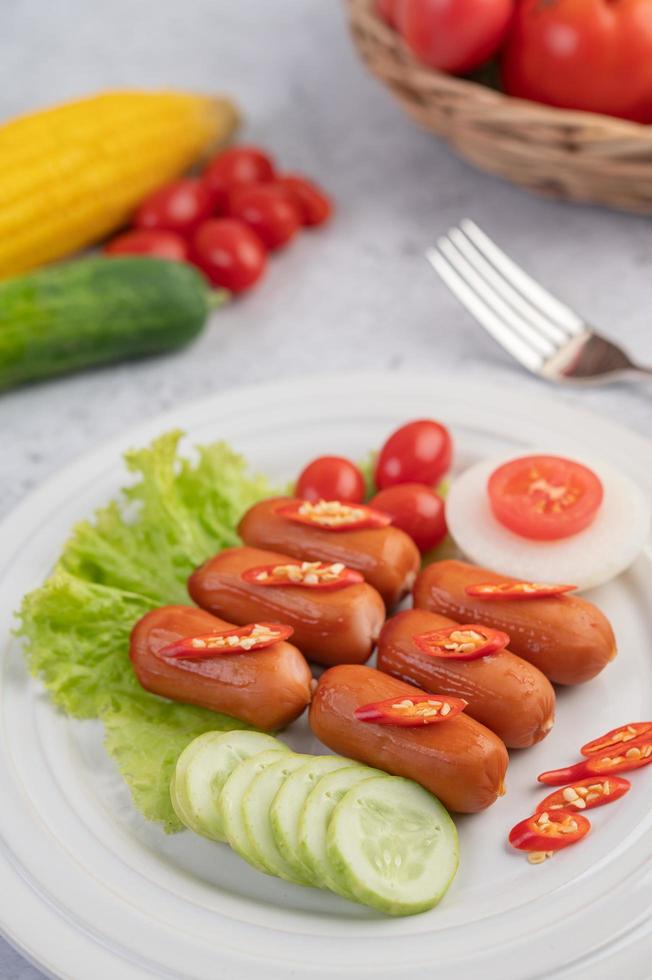 Sausage links with peppers and cucumbers photo