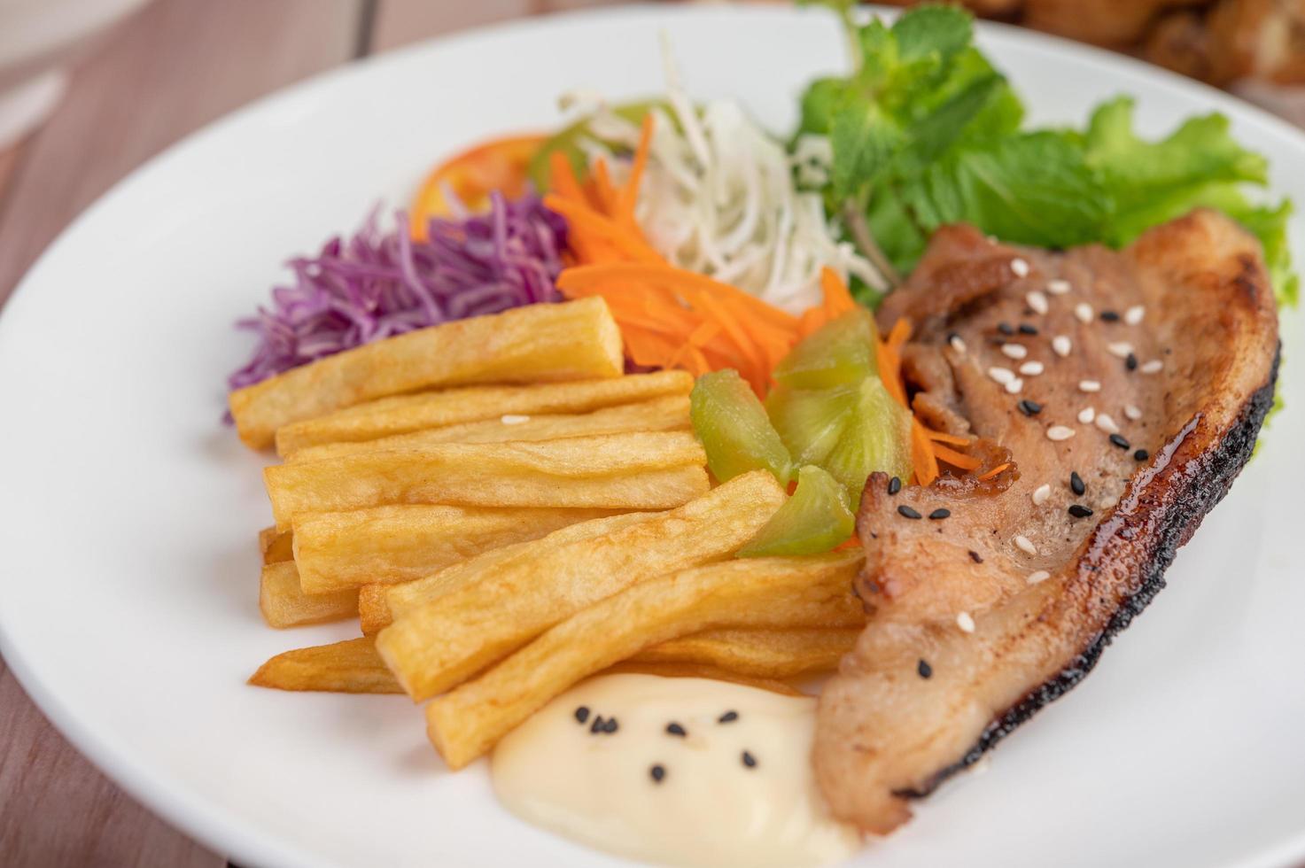 Fish steak with french fries and salad photo