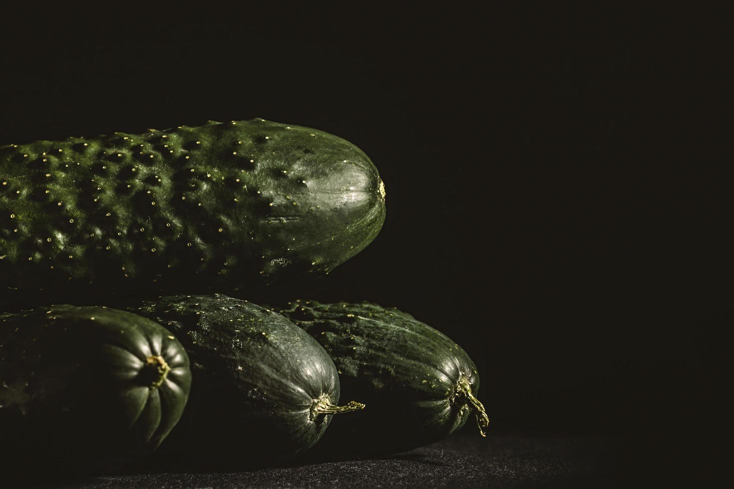 Cucumbers on dark background photo