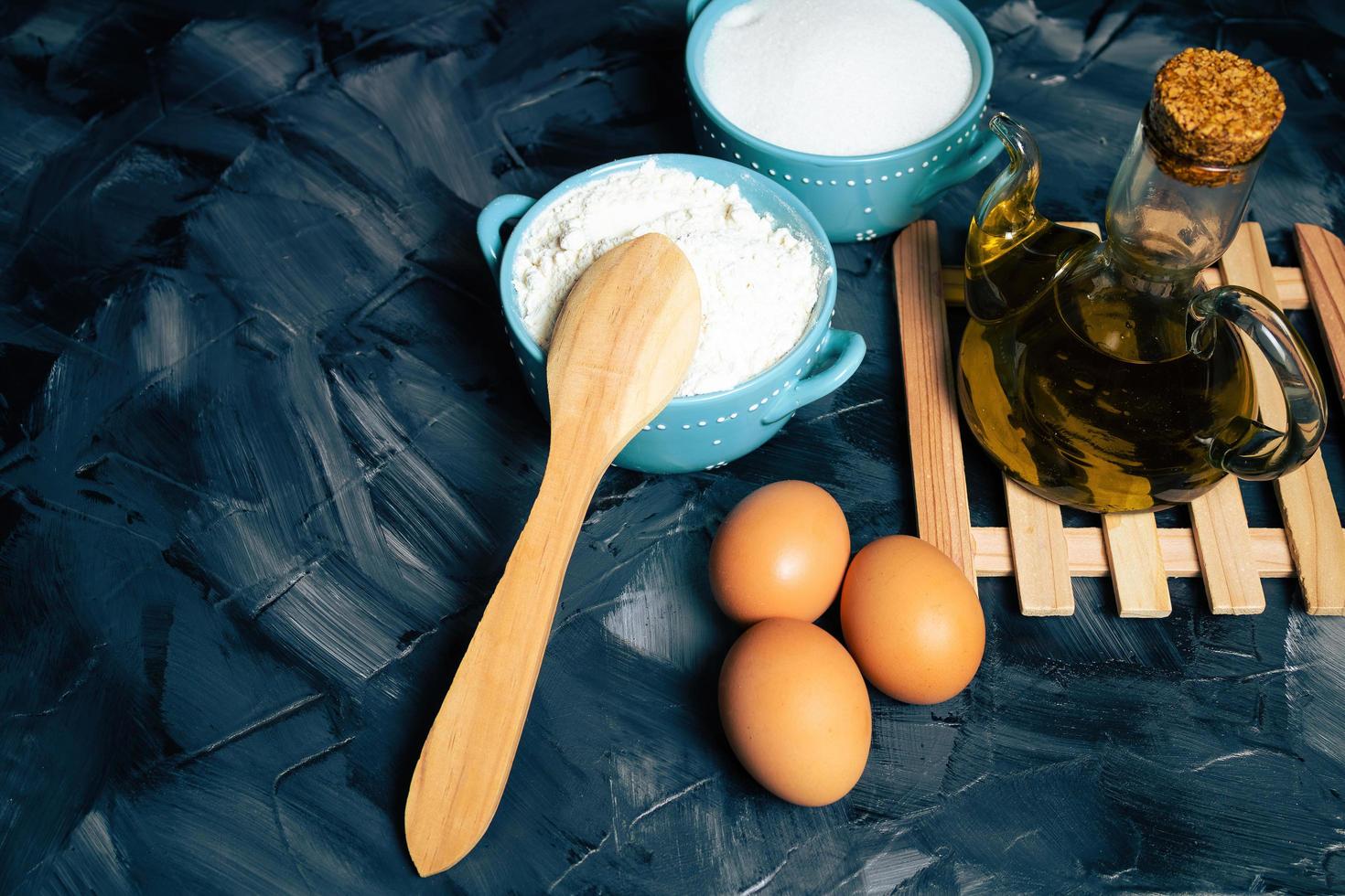 Baking ingredients with a wooden spoon photo