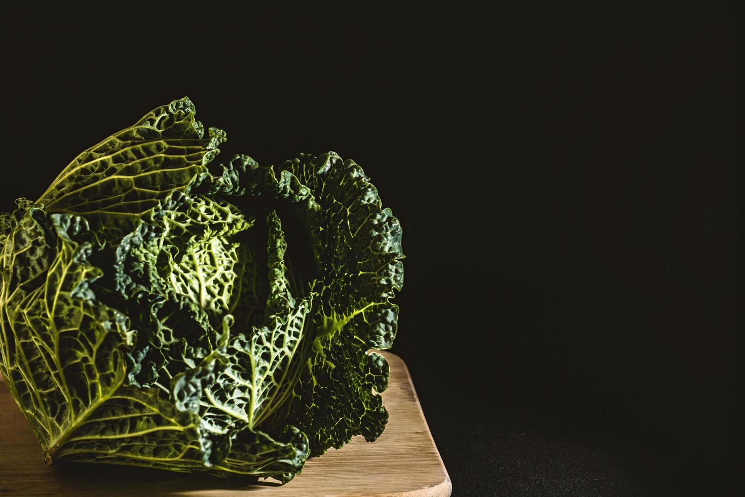 Cabbage on a wooden board with a dark background photo