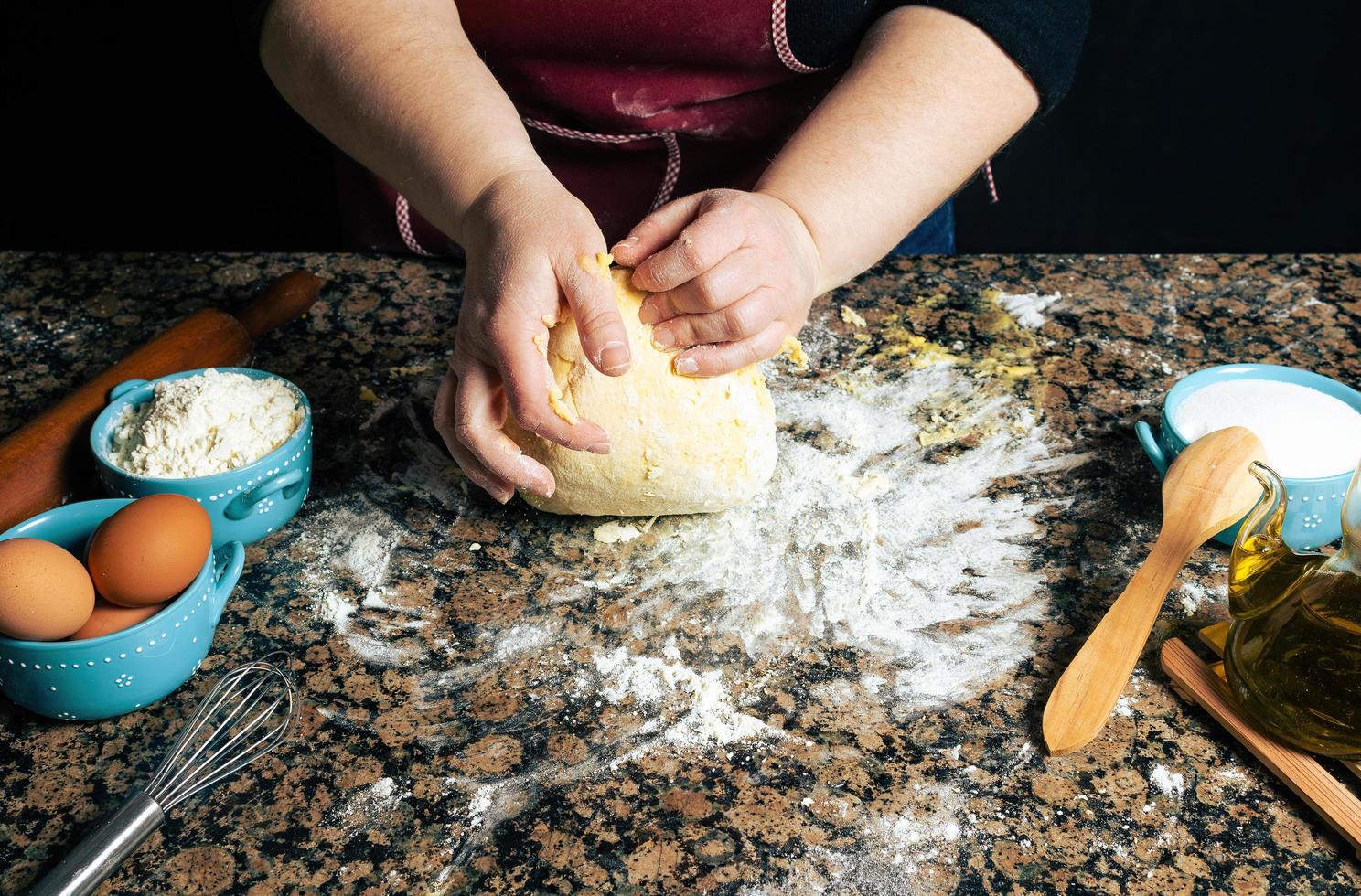 Person kneading dough photo