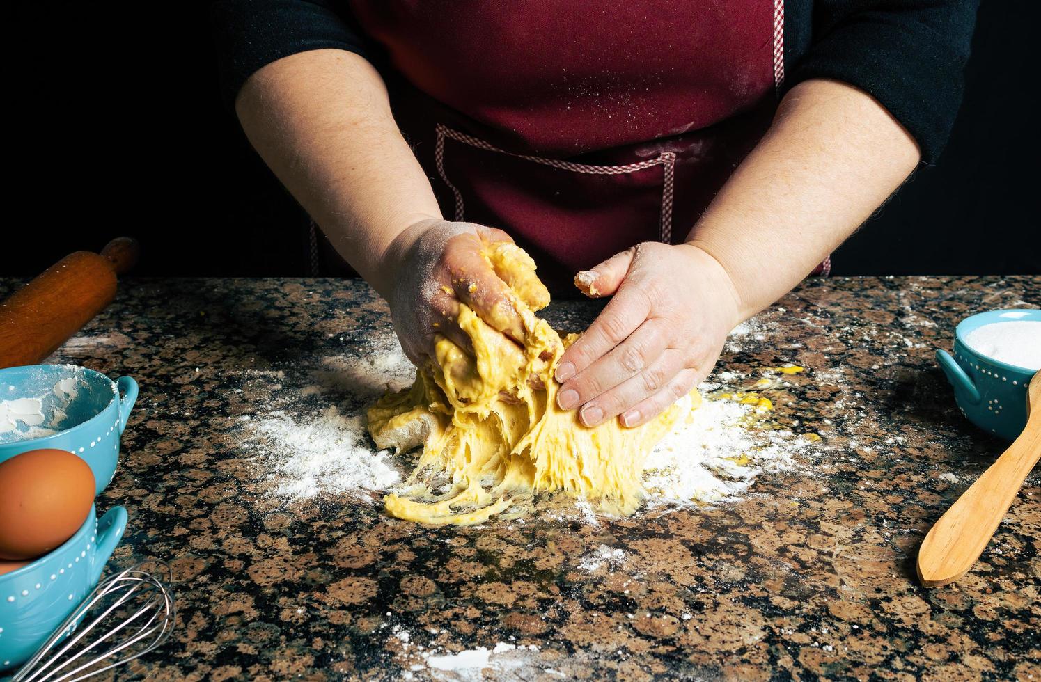 Person kneading dough on a counter photo