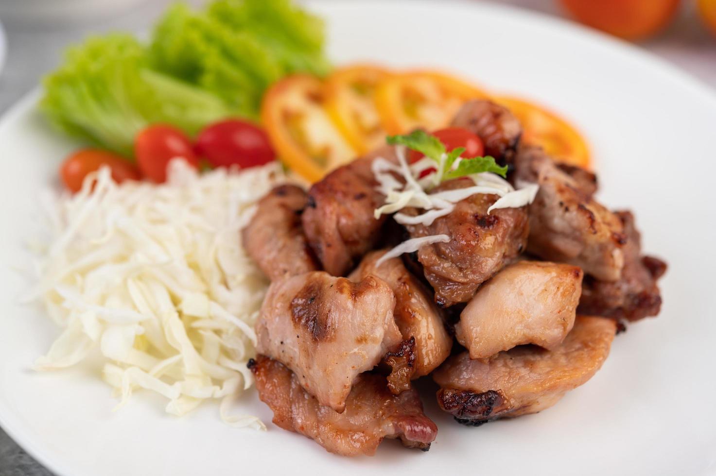 Grilled pork cutlet with tomatoes and salad photo