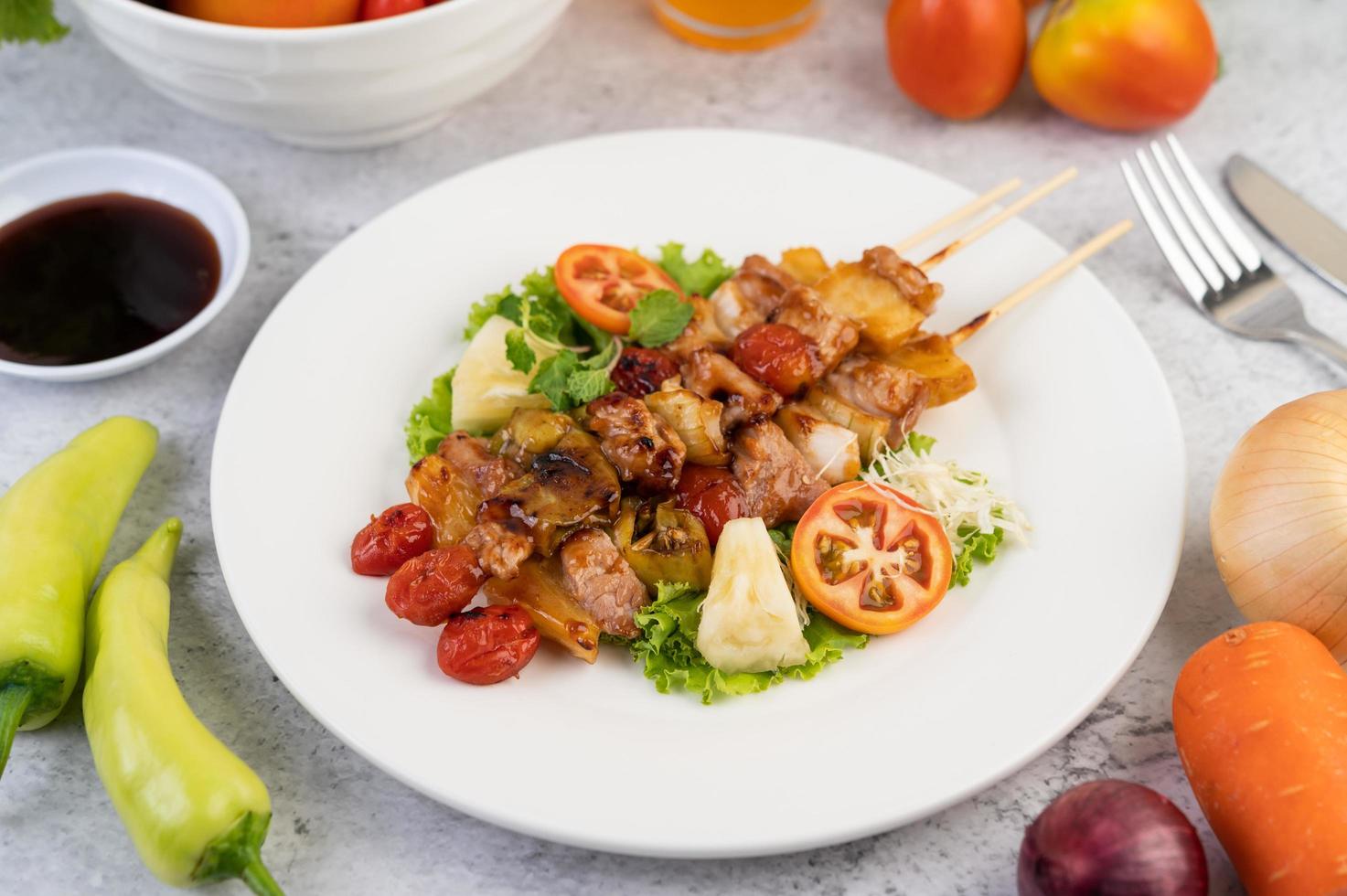 BBQ meat with tomatoes and bell peppers photo