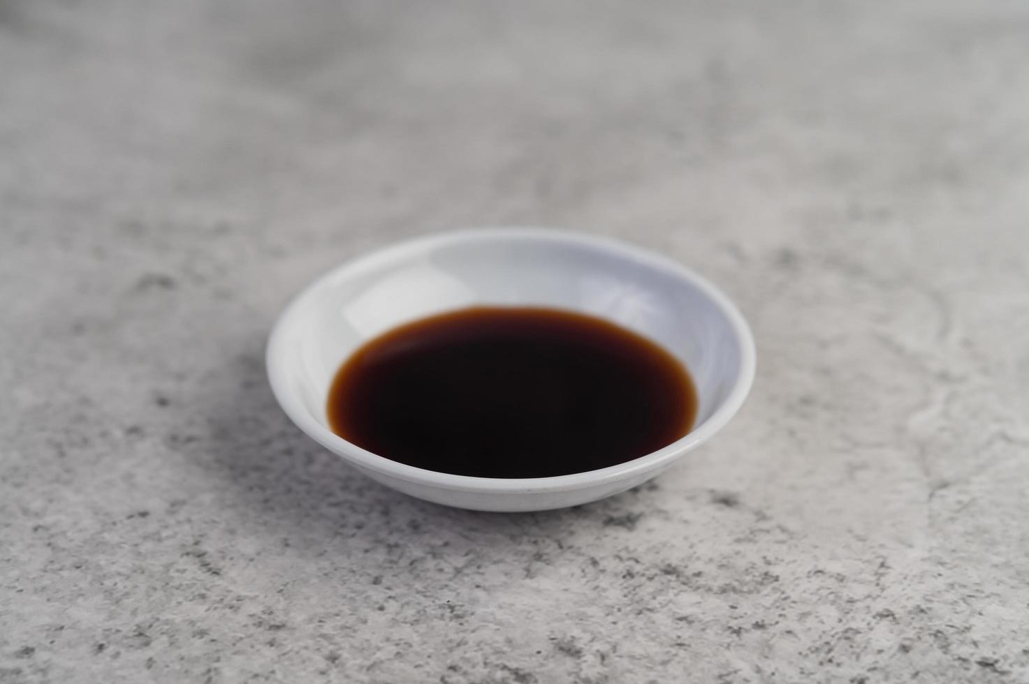 Sauce in a small white cup photo