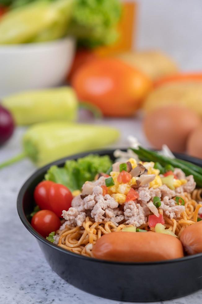 Stir-fried noodles with minced pork, edamame, tomatoes and mushrooms photo