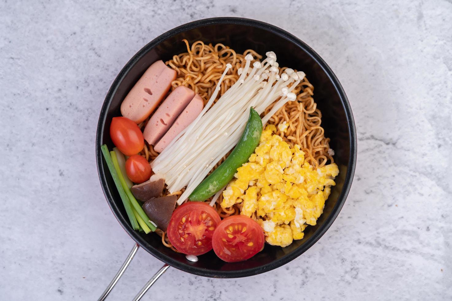 Stir-fried noodles with corn, golden needle mushroom, tomato, sausage and edamame photo