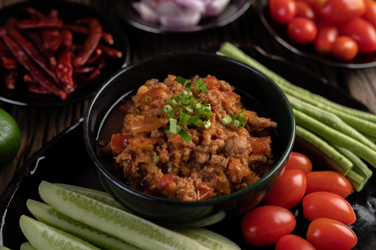 Sweet pork bowl with cucumbers, long beans and tomatoes photo