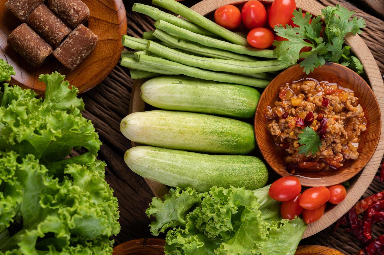 Sweet pork in a wooden bowl with ingredients photo